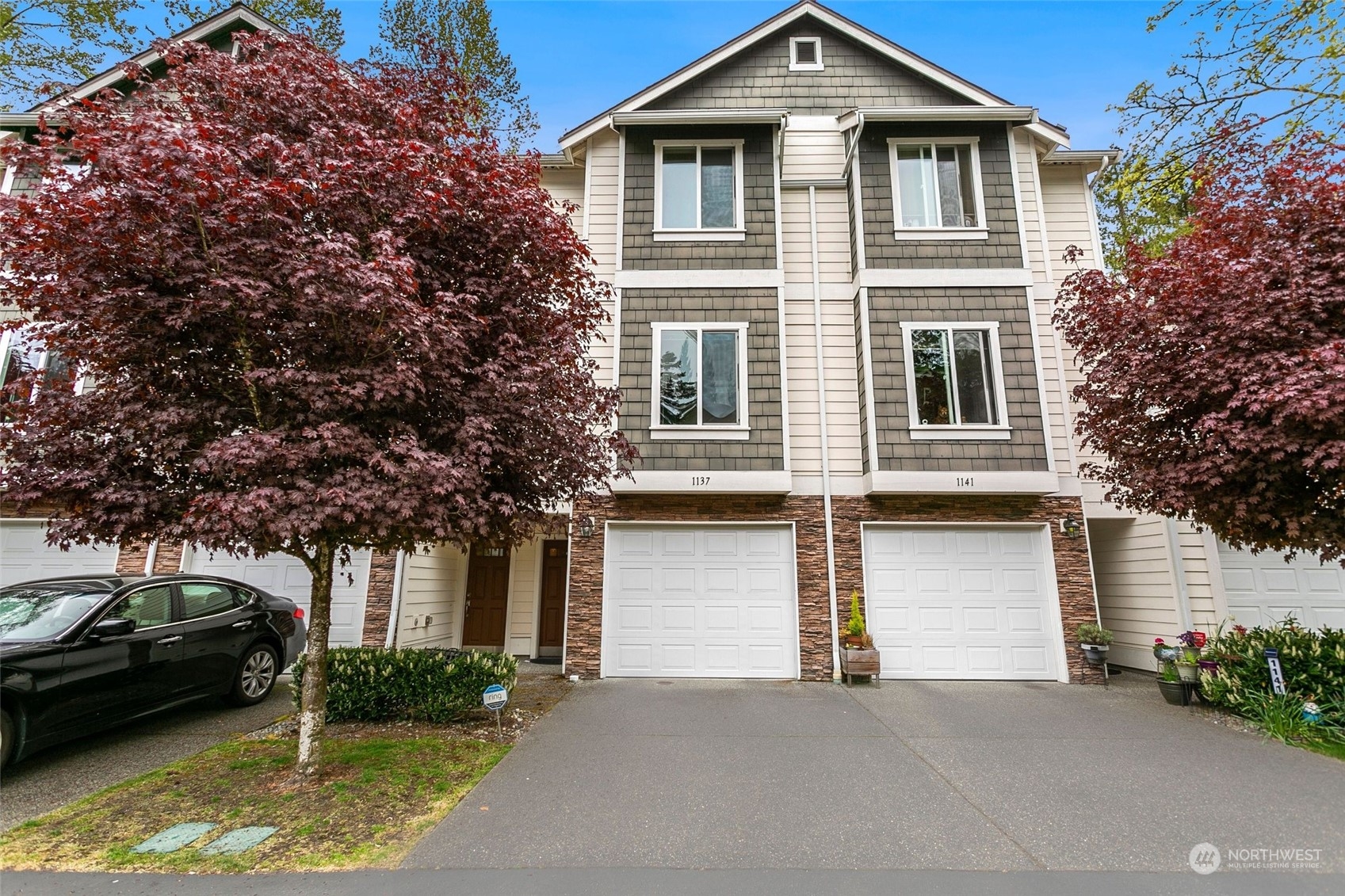 a front view of a house with a garden and parking
