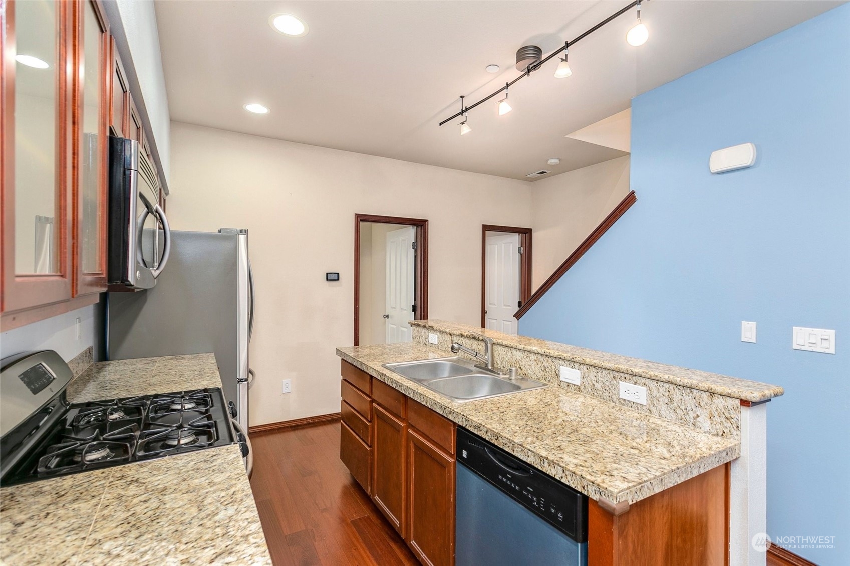 1137 215th Place Southeast Bothell, WA 98021 - Photo 11 of 30 a kitchen with granite countertop a sink and cabinets