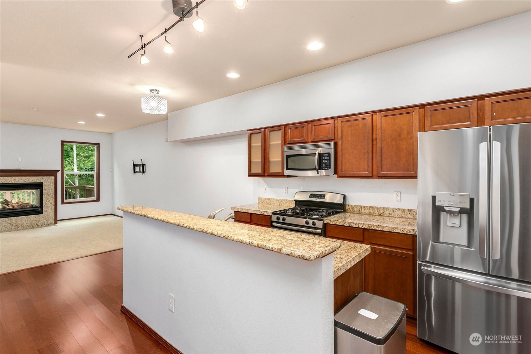 1137 215th Place Southeast Bothell, WA 98021 - Photo 12 of 30 a kitchen with stainless steel appliances a refrigerator stove microwave and sink