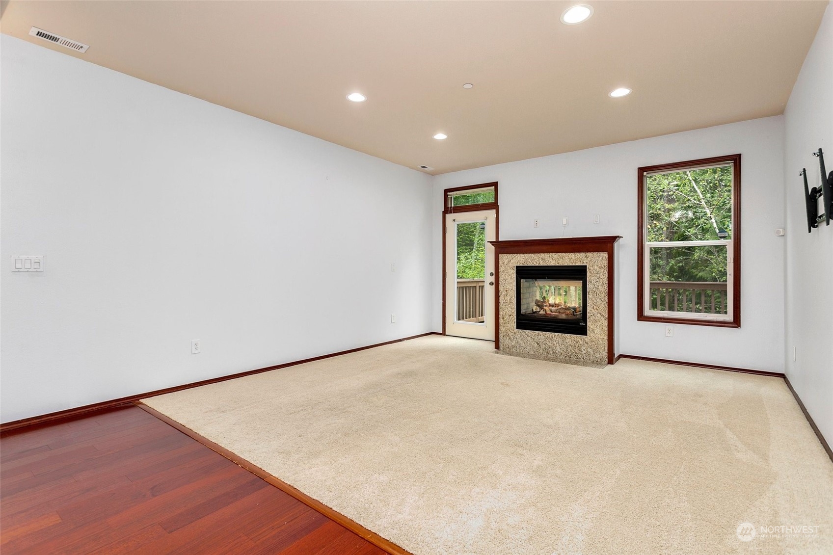 1137 215th Place Southeast Bothell, WA 98021 - Photo 7 of 30 a view of an empty room with a fireplace and a window