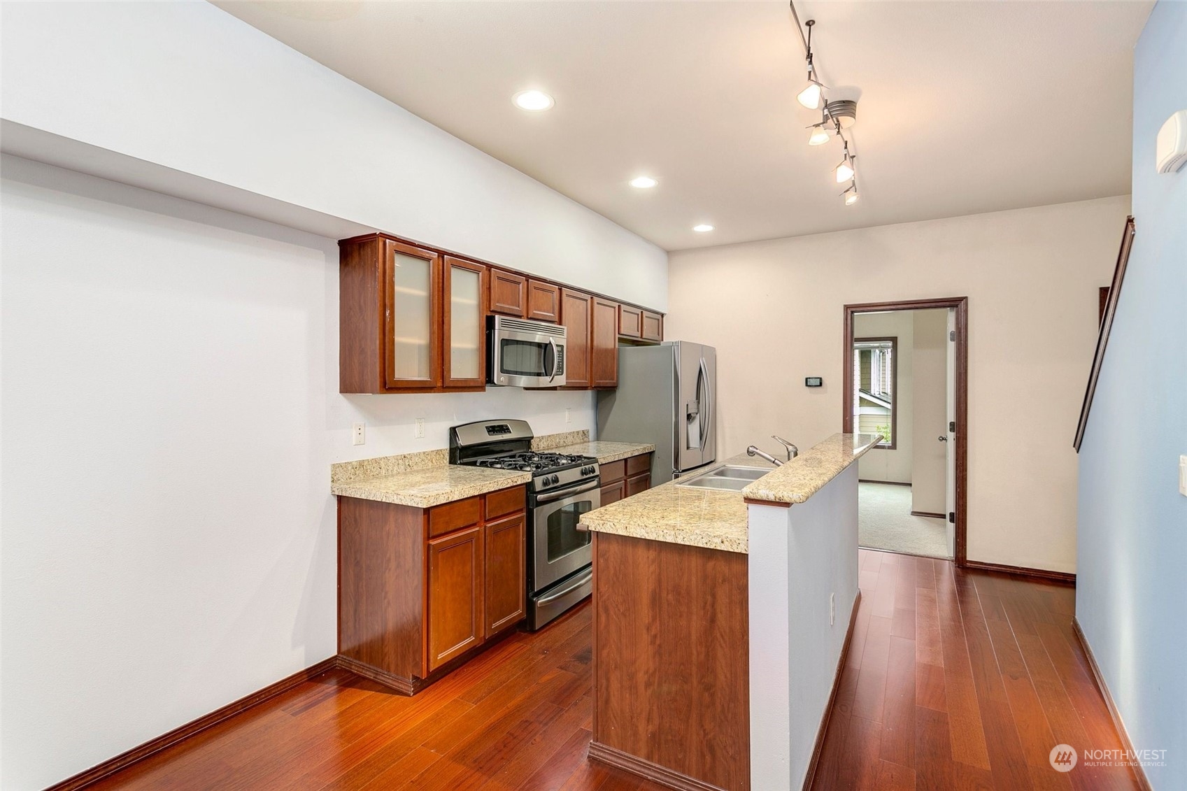 1137 215th Place Southeast Bothell, WA 98021 - Photo 9 of 30 a kitchen with stainless steel appliances granite countertop a sink stove and refrigerator