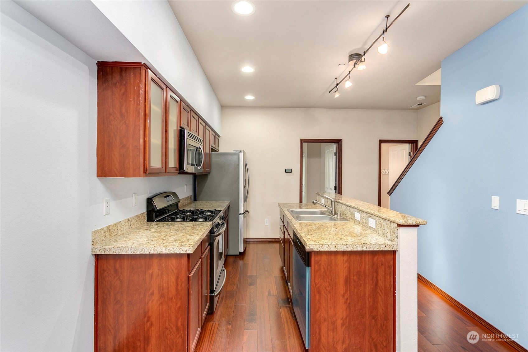 1137 215th Place Southeast Bothell, WA 98021 - Photo 10 of 30 a kitchen with a granite countertop sink stove and refrigerator