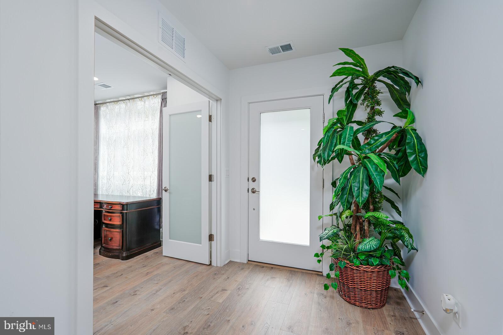 5345 Zenith Overlook Bethesda, MD 20816 - Photo 6 of 53 a room with potted plants and wooden floor