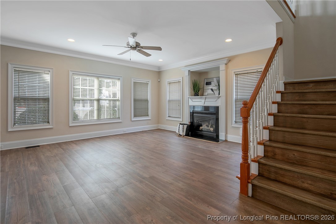 2721 Plum Ridge Road Fayetteville, NC 28306 - Photo 11 of 50 a view of an empty room with wooden floor fireplace and a window