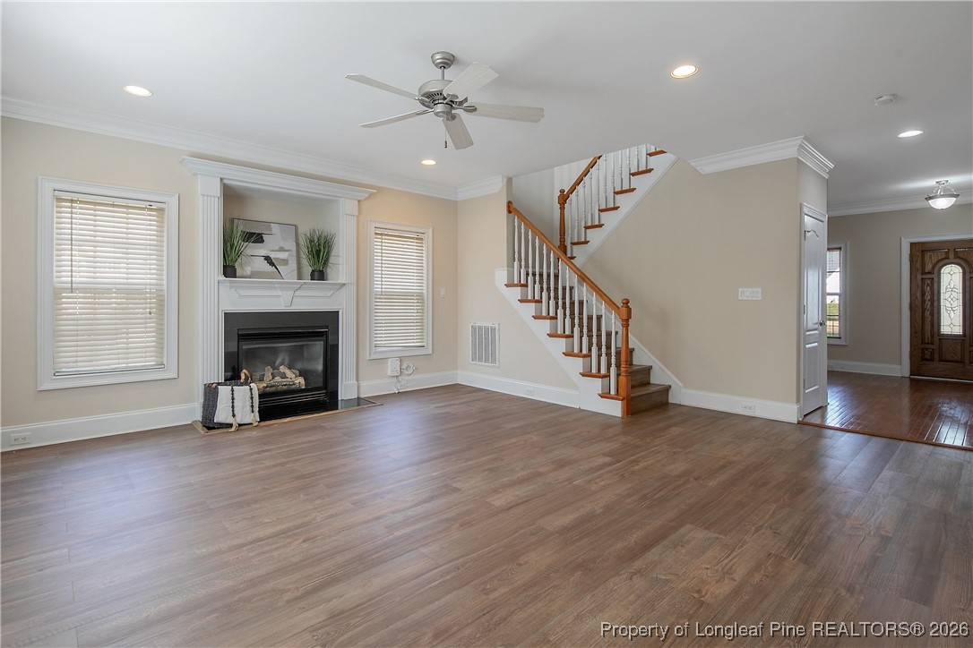 2721 Plum Ridge Road Fayetteville, NC 28306 - Photo 13 of 50 a view of an empty room with wooden floor fireplace and a window