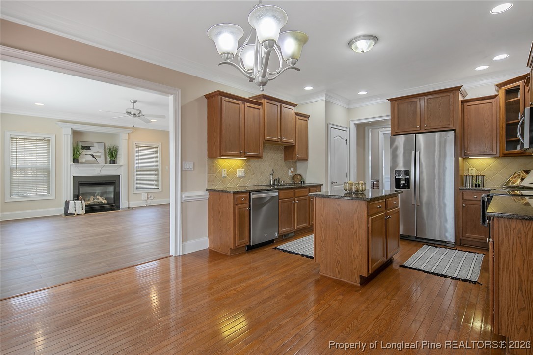 2721 Plum Ridge Road Fayetteville, NC 28306 - Photo 16 of 50 a kitchen with granite countertop stainless steel appliances a counter top space and cabinets