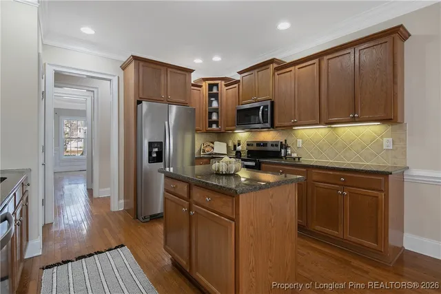 a kitchen with a refrigerator sink and cabinets