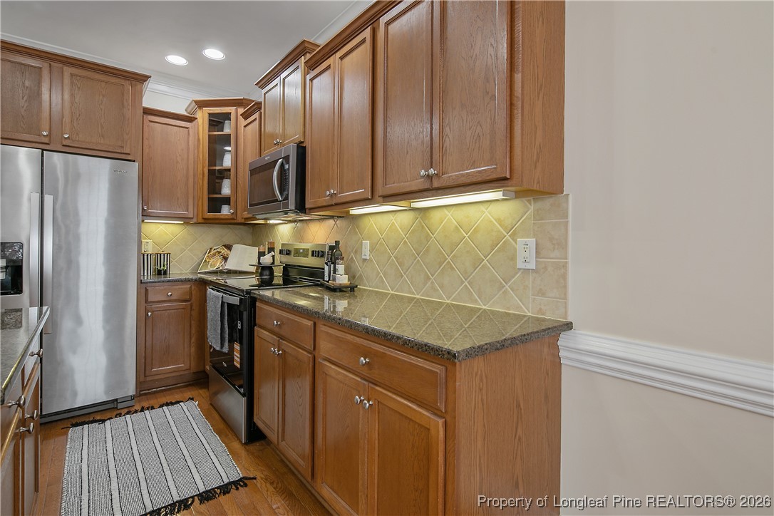 2721 Plum Ridge Road Fayetteville, NC 28306 - Photo 19 of 50 a kitchen with a refrigerator sink and cabinets