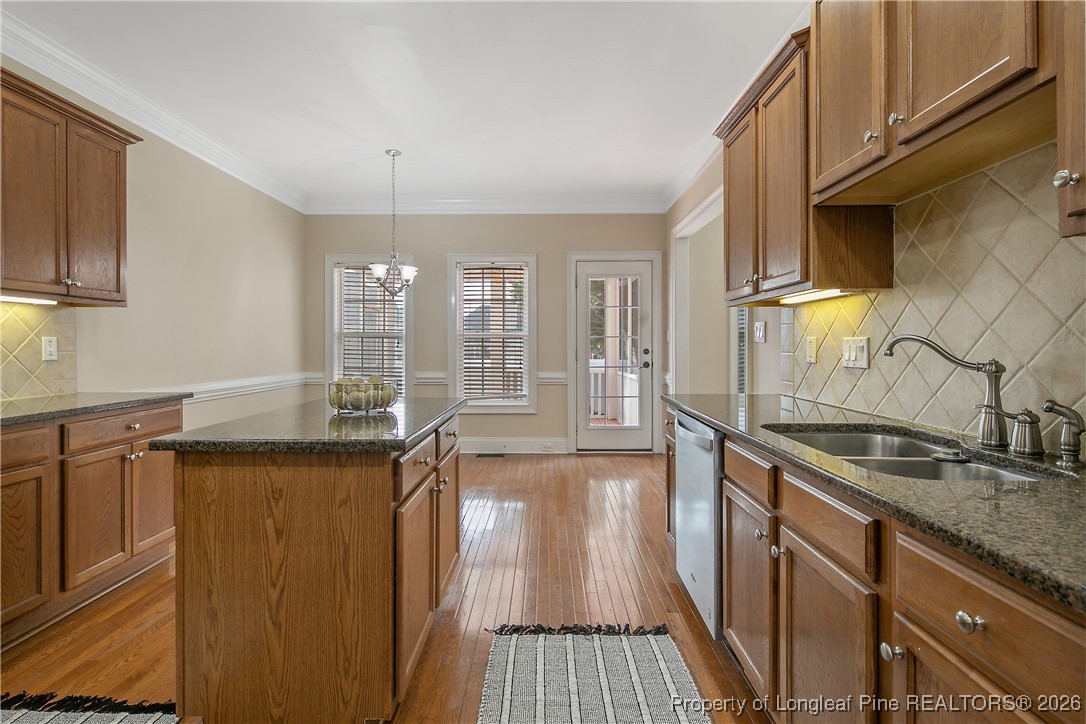2721 Plum Ridge Road Fayetteville, NC 28306 - Photo 20 of 50 a kitchen with granite countertop a sink stove and cabinets