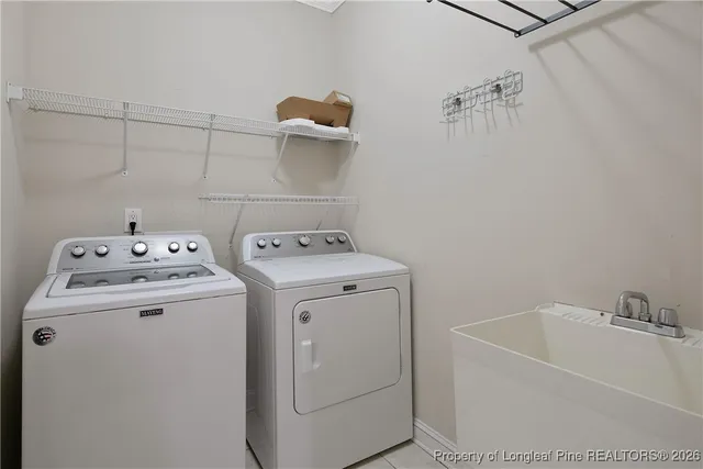 an empty room with wooden floor ceiling fan and windows
