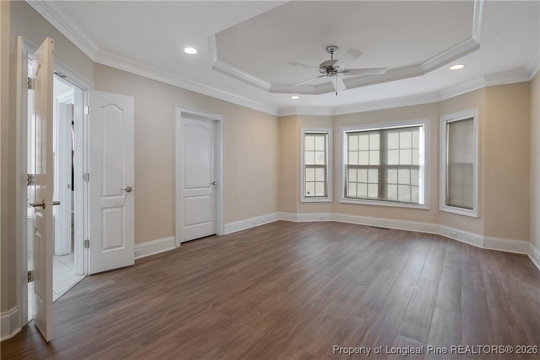 2721 Plum Ridge Road Fayetteville, NC 28306 - Photo 23 of 50 an empty room with wooden floor ceiling fan and windows