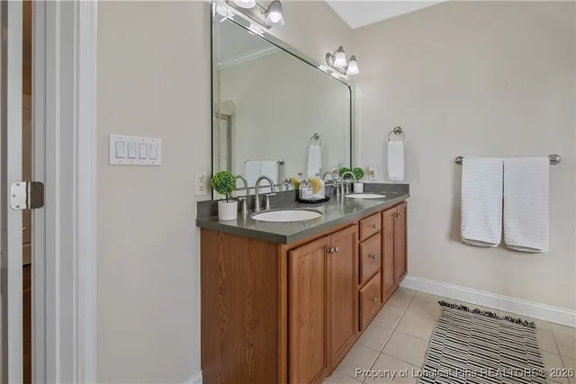 a spacious bathroom with a granite countertop sink a mirror and a shower