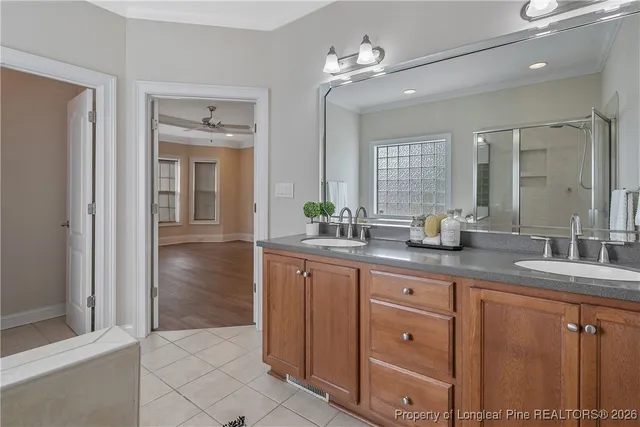 a bathroom with a tub shower and sink