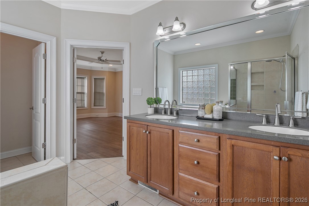 2721 Plum Ridge Road Fayetteville, NC 28306 - Photo 28 of 50 a spacious bathroom with a granite countertop sink a mirror and a shower