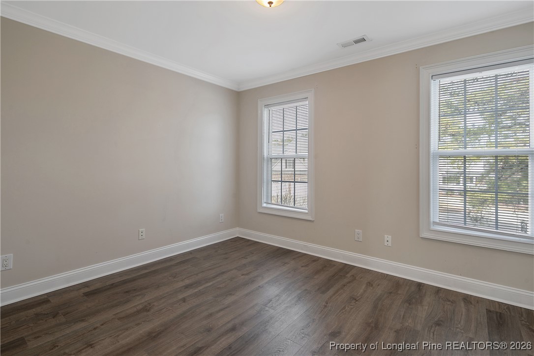 2721 Plum Ridge Road Fayetteville, NC 28306 - Photo 33 of 50 an empty room with wooden floor and windows