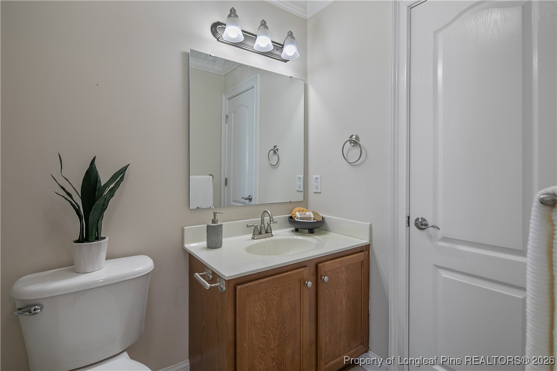 2721 Plum Ridge Road Fayetteville, NC 28306 - Photo 36 of 50 a bathroom with a toilet sink and mirror