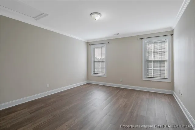 a view of an empty room and wooden floor