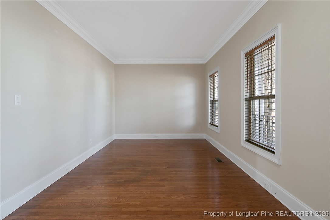 2721 Plum Ridge Road Fayetteville, NC 28306 - Photo 6 of 50 an empty room with wooden floor and windows