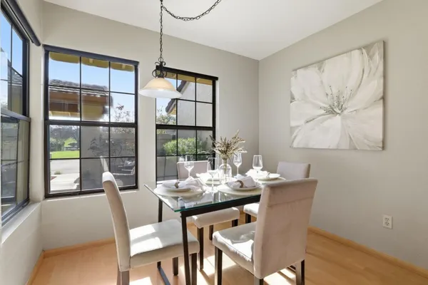 a view of a dining room with furniture and chandelier