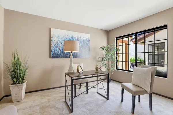 a living room with furniture and a large window