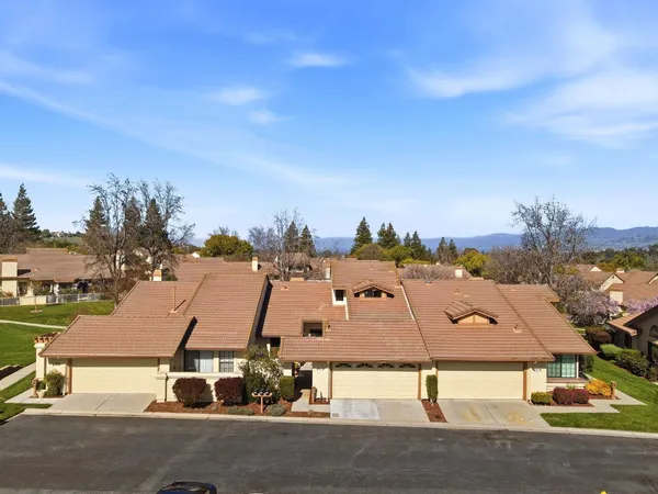 an aerial view of residential houses with outdoor space