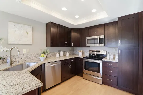 a kitchen with a refrigerator and a sink