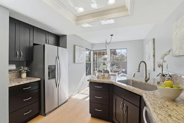 a kitchen with lots of counter space a sink and appliances