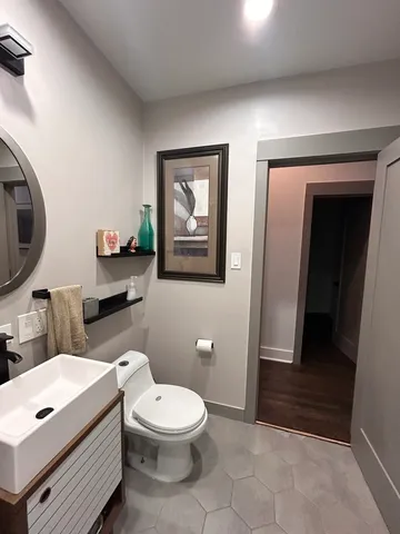 a bathroom with a toilet a sink and mirror