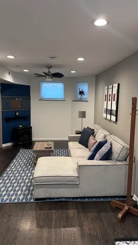 a living room with furniture and a wooden floor