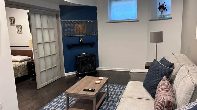 a living room with furniture a rug and a window