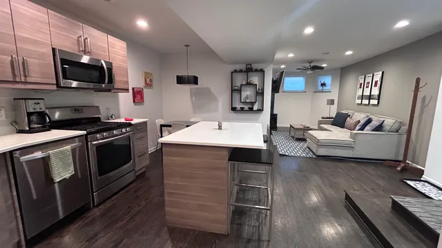 a large white kitchen with stainless steel appliances