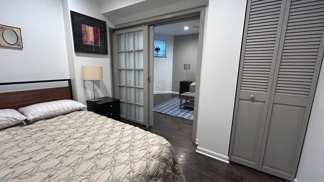 a bedroom with a bed and a television