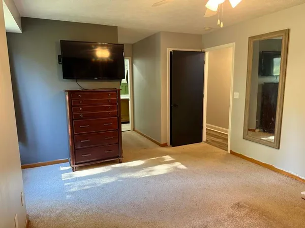 a view of a livingroom with an empty space and a flat screen tv