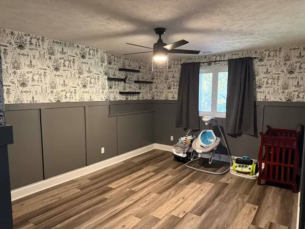 a room with wooden floor and furniture