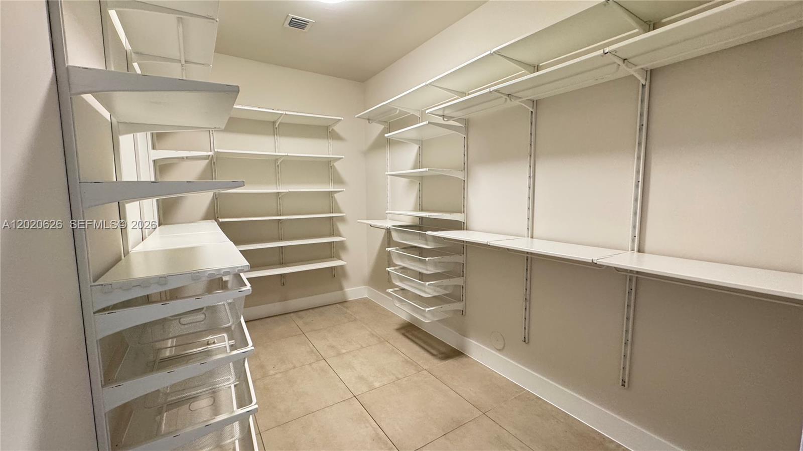 7701 Southwest 95th Terrace, Unit 1 Miami, FL 33156 - Photo 16 of 18 a refrigerator in a kitchen with white cabinets