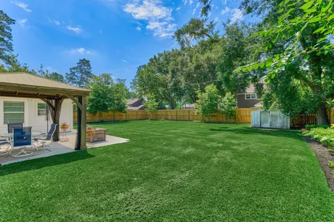 a view of a house with backyard porch and sitting area