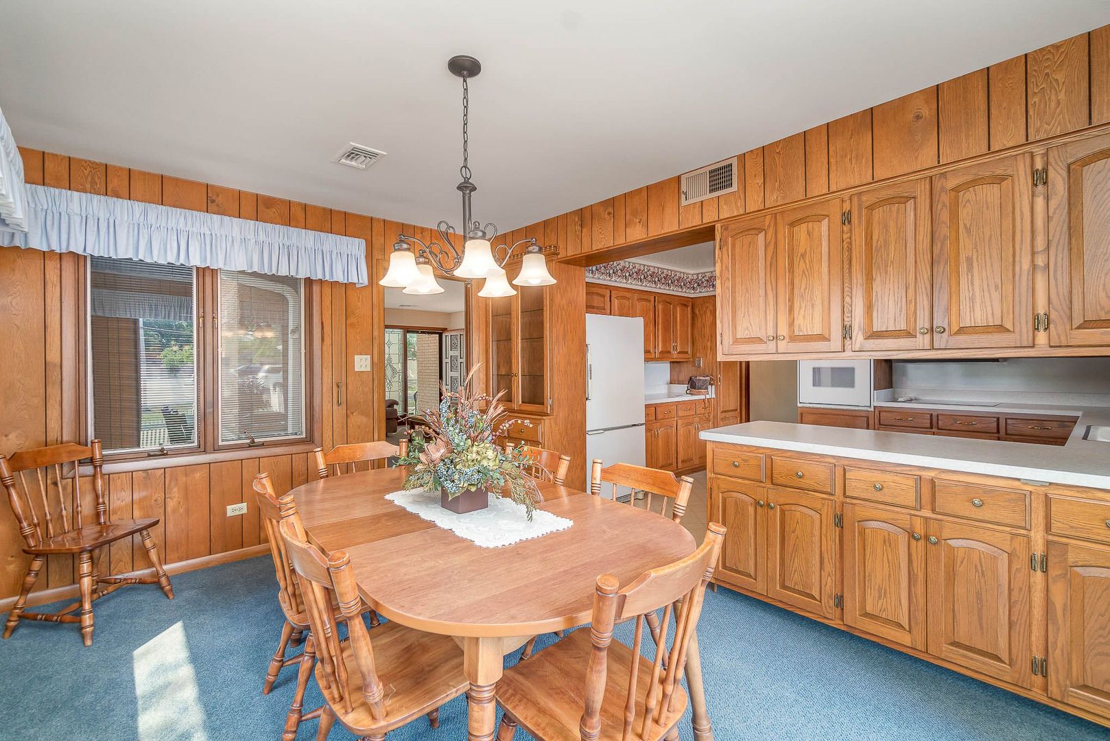 18561 Bock Road Lansing, IL 60438 - Photo 14 of 38 a open kitchen with stainless steel appliances granite countertop a refrigerator a sink dishwasher a dining table and chairs with wooden floor