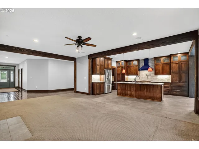 a living room with stainless steel appliances kitchen island granite countertop furniture and a kitchen view