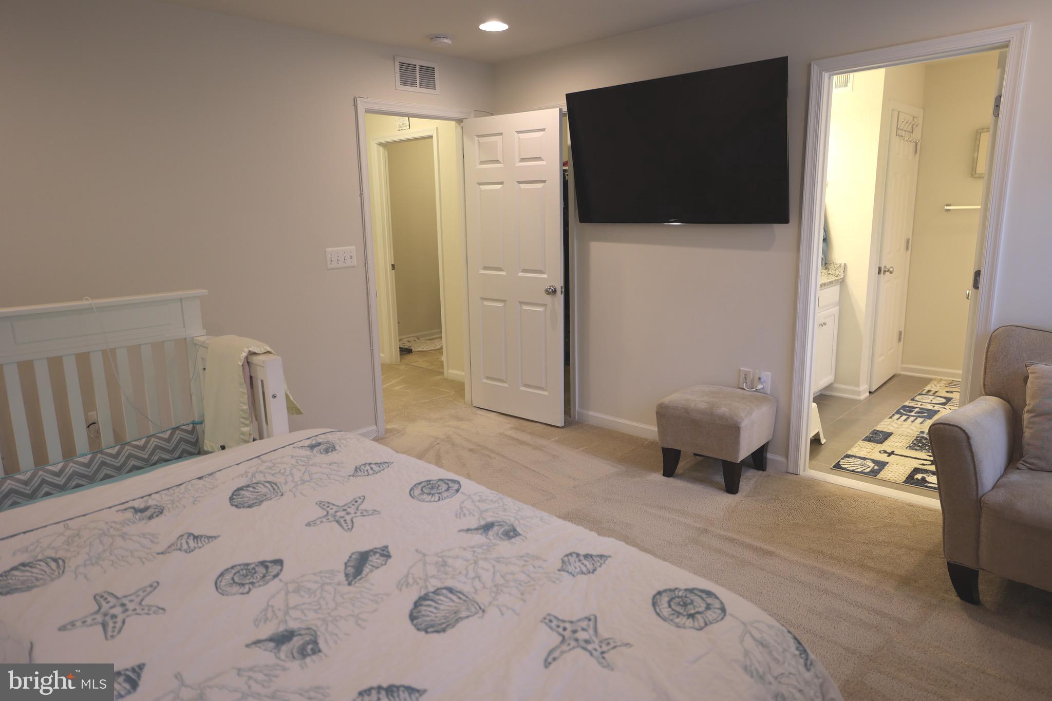 130 Intrepid Lane Berlin, MD 21811 - Photo 12 of 18 a bedroom with a bed and a flat screen tv
