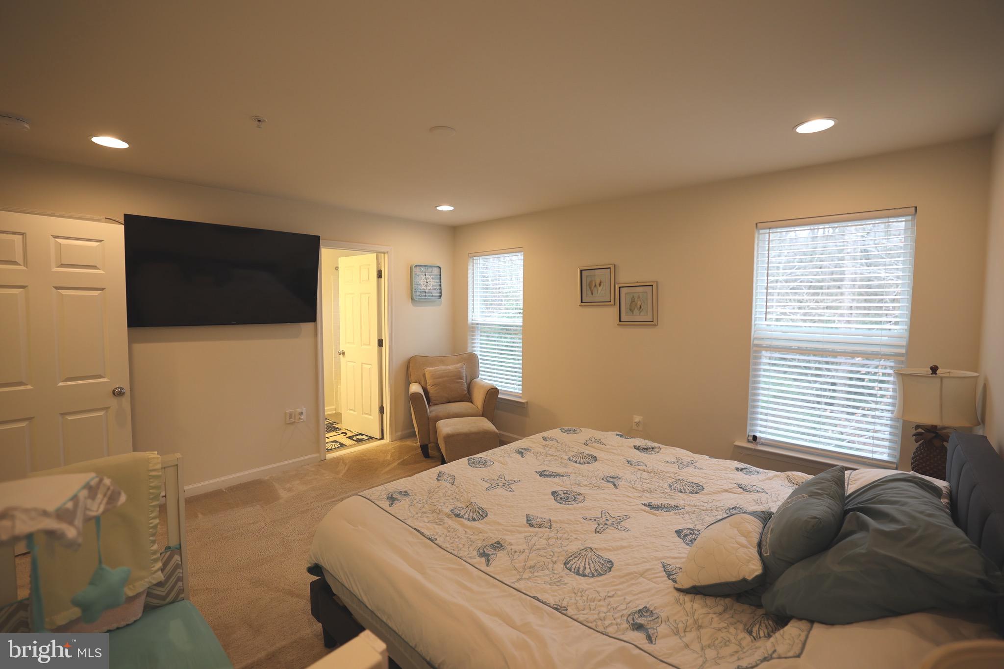 130 Intrepid Lane Berlin, MD 21811 - Photo 13 of 18 a bedroom with a bed and a flat screen tv