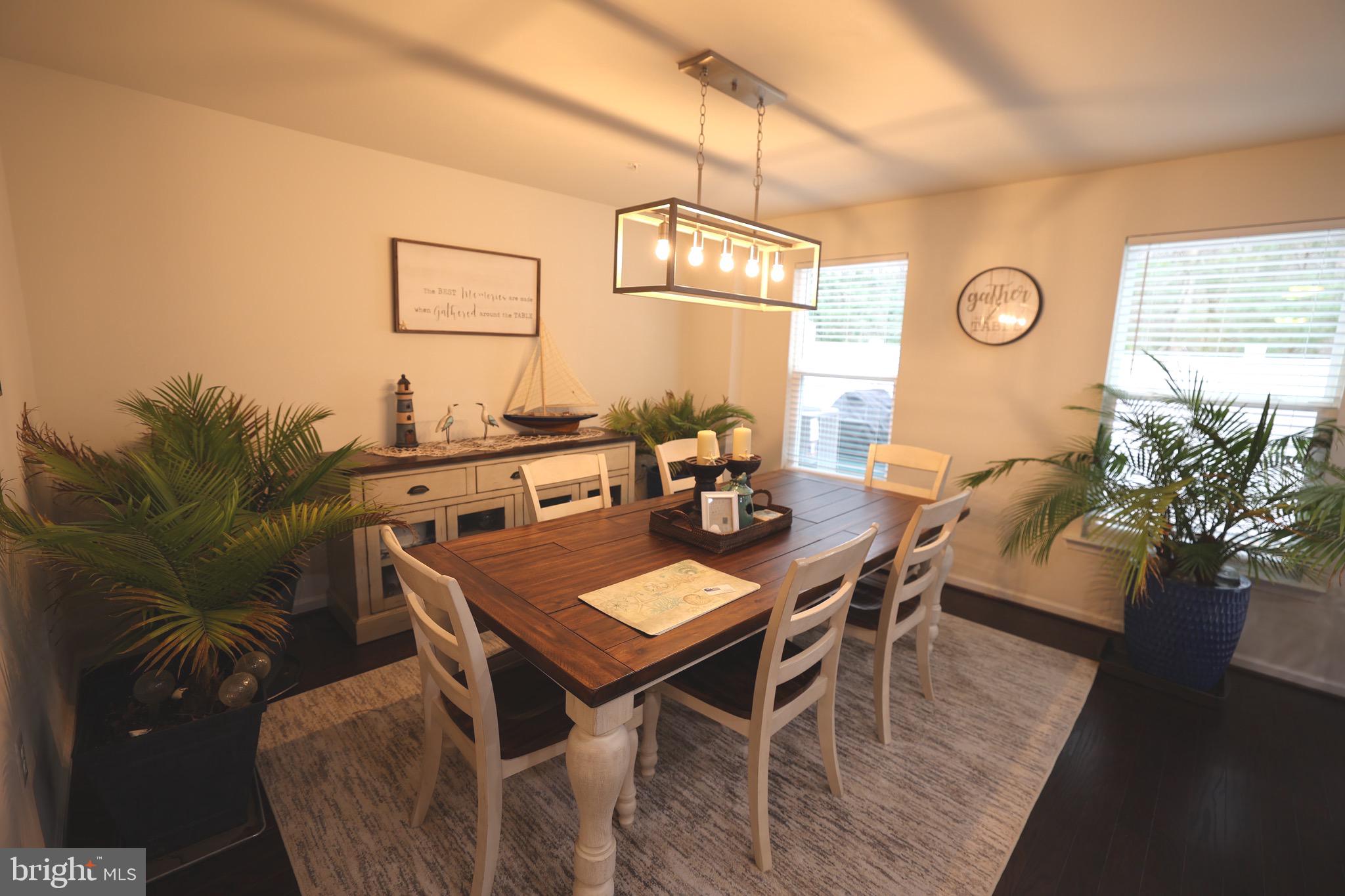130 Intrepid Lane Berlin, MD 21811 - Photo 6 of 18 a view of a dining room with furniture and wooden floor