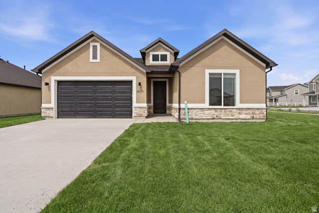 401 West 3085 South, Unit 329 Nibley, UT 84321 - Photo 1 of 34 View of front of house featuring stone siding, stucco siding, and an attached garage