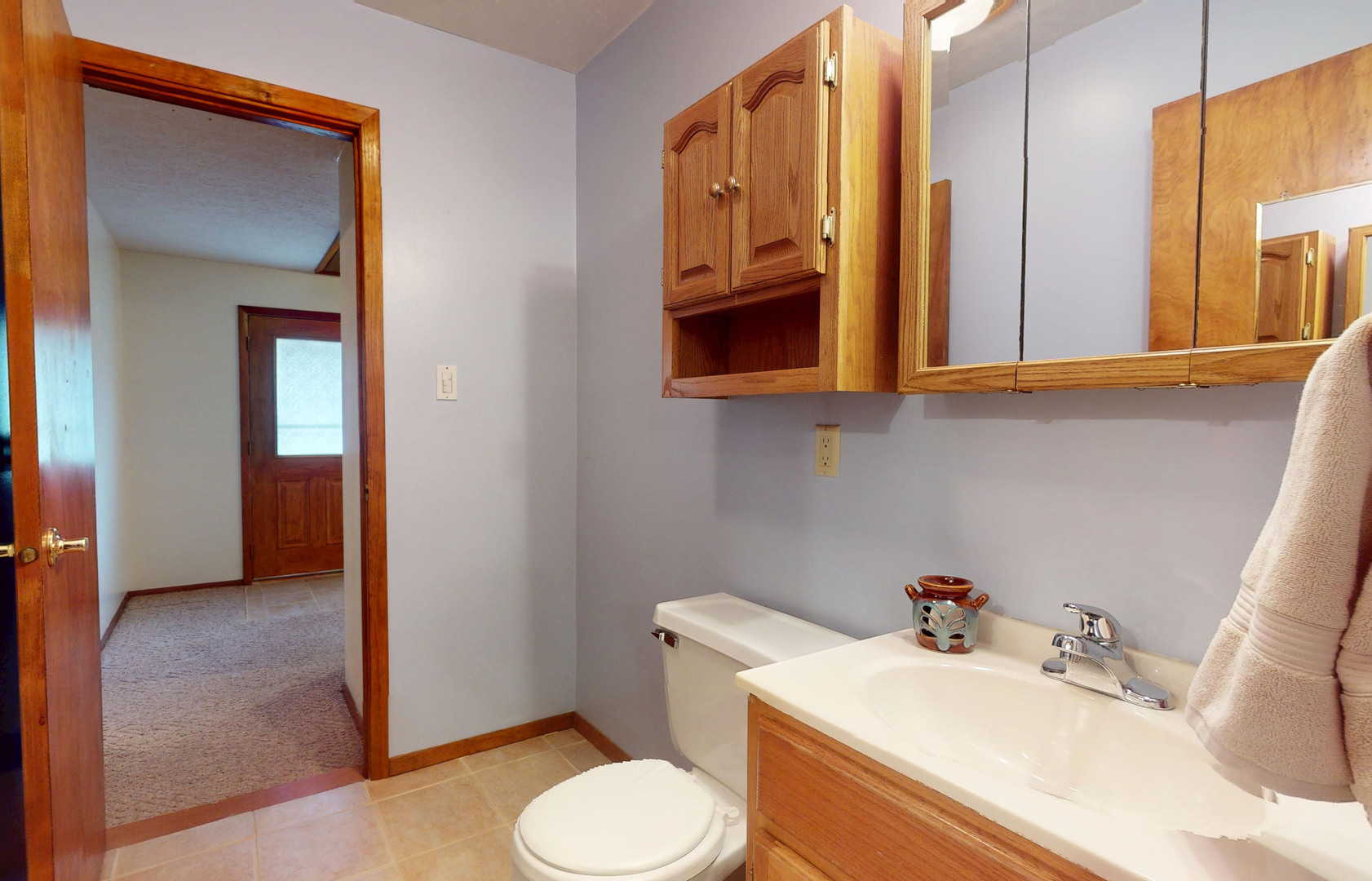 1424 Harper Drive Rantoul, IL 61866 - Photo 11 of 14 a bathroom with a sink a toilet and mirror