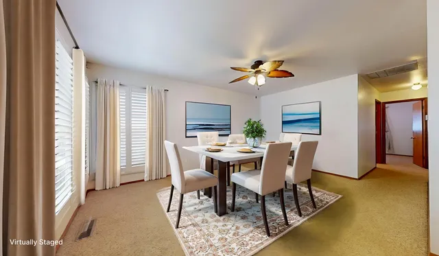 a view of a dining room with furniture and a window
