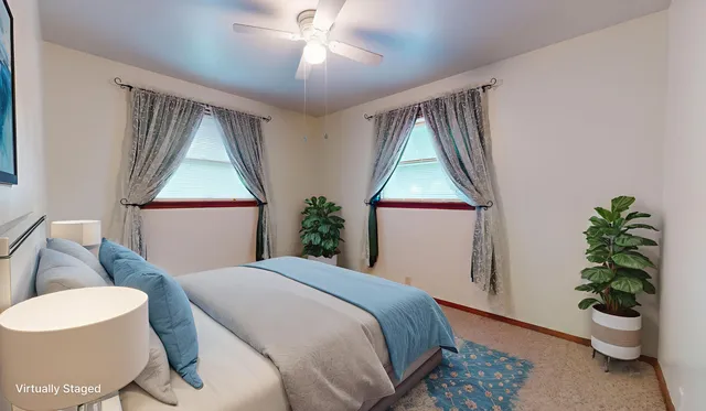 a bedroom with a bed and a potted plant