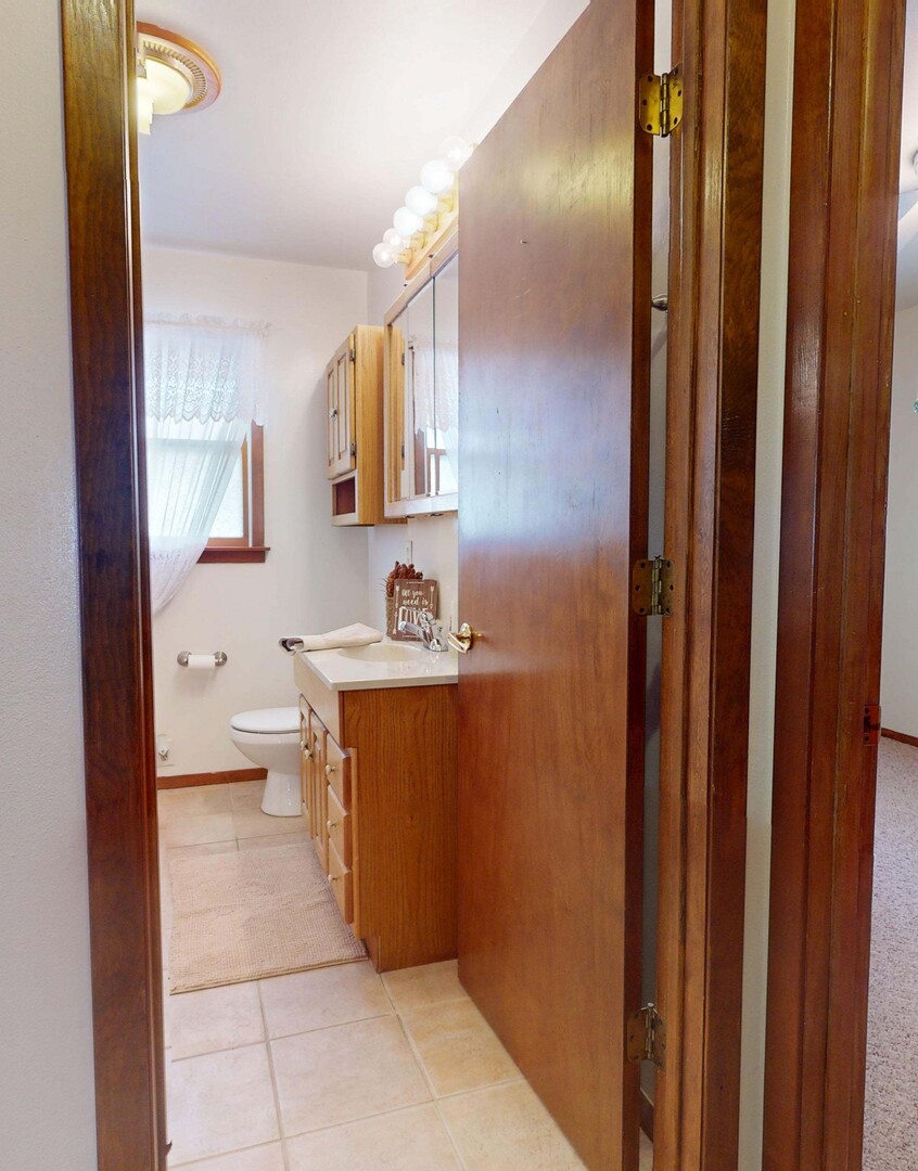 1424 Harper Drive Rantoul, IL 61866 - Photo 8 of 14 a bathroom with a sink a toilet and shower