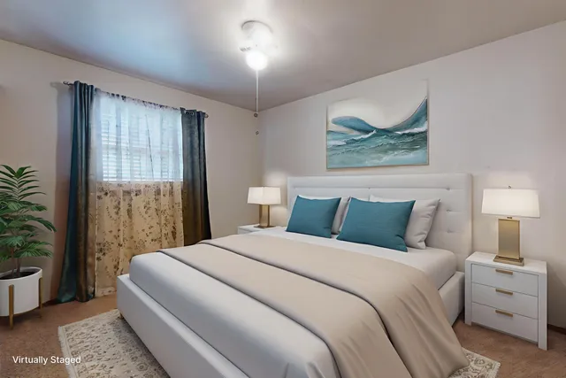 a bedroom with a bed and a painting on the wall