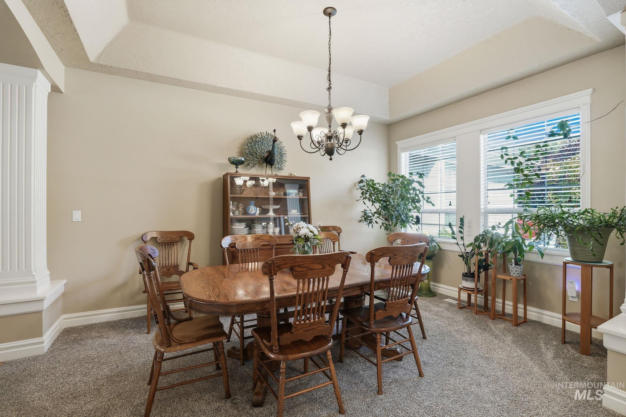 3969 North Hollymount Way Meridian, ID 83646 - Photo 19 of 47 Tray ceiling with perimeter lighting, recessed lighting, and a multi-bulb chandelier