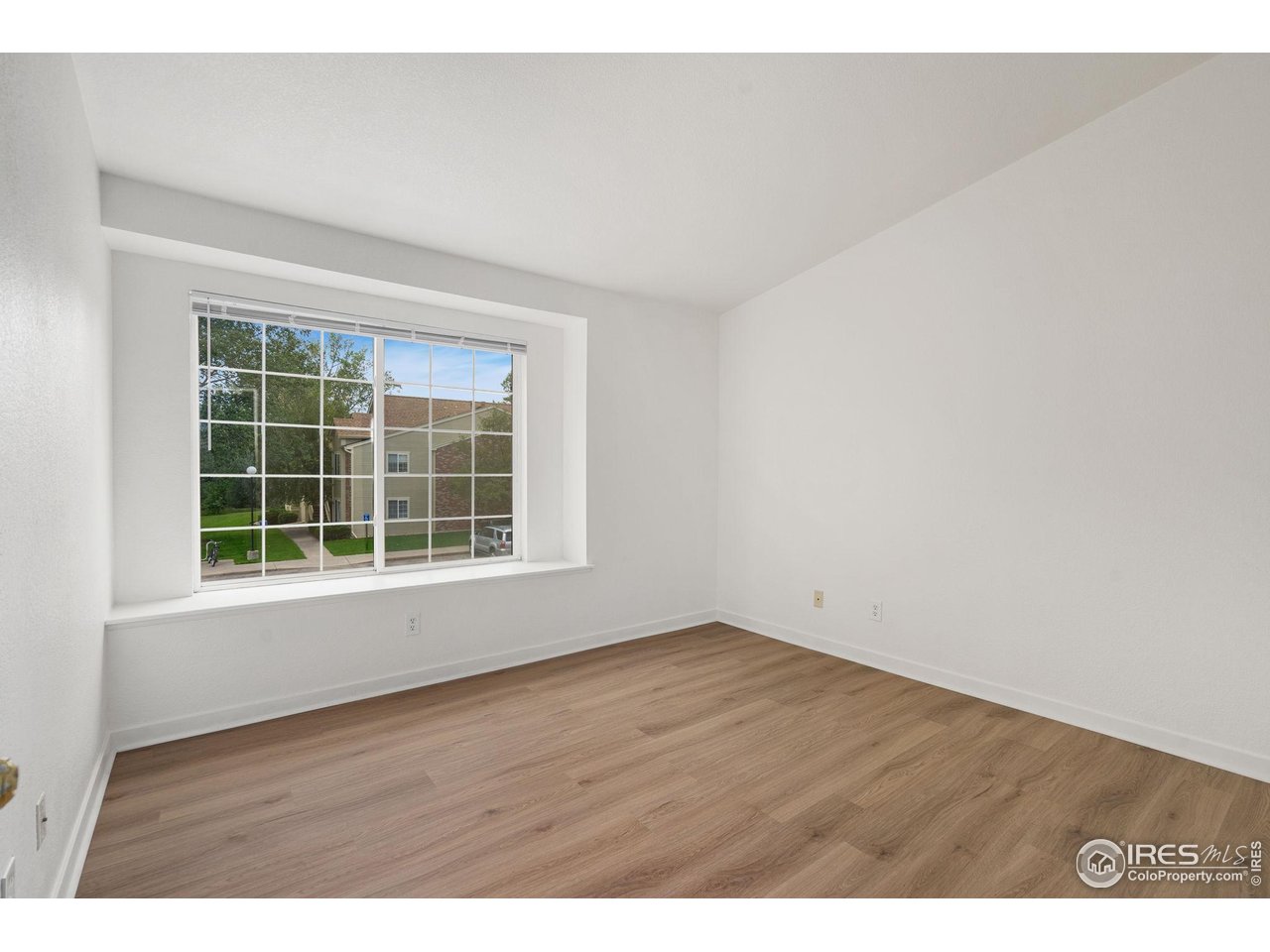 1225 West Prospect Road, Unit R47 Fort Collins, CO 80526 - Photo 13 of 25 The main level bedroom has a cozy deep-set window seat offering tranquil views.