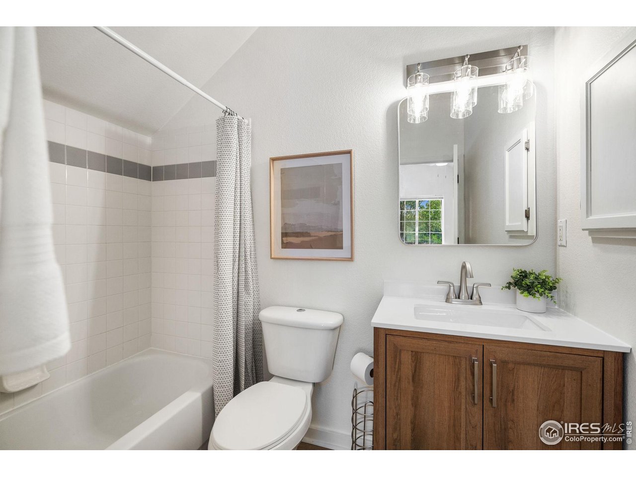 1225 West Prospect Road, Unit R47 Fort Collins, CO 80526 - Photo 20 of 25 A beautifully refreshed bathroom with a new vanity, mirror, and light fixture creating a bright and stylish space.